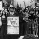 Bella Abzug, one of the chief organisers of the Women’s Liberation Day parade in New York, on the 50th anniversary of women winning the vote in the United States. She is carrying an anti-motherhood sign reading ‘Free the female body from pain and inequality. Put motherhood in a test-tube’.